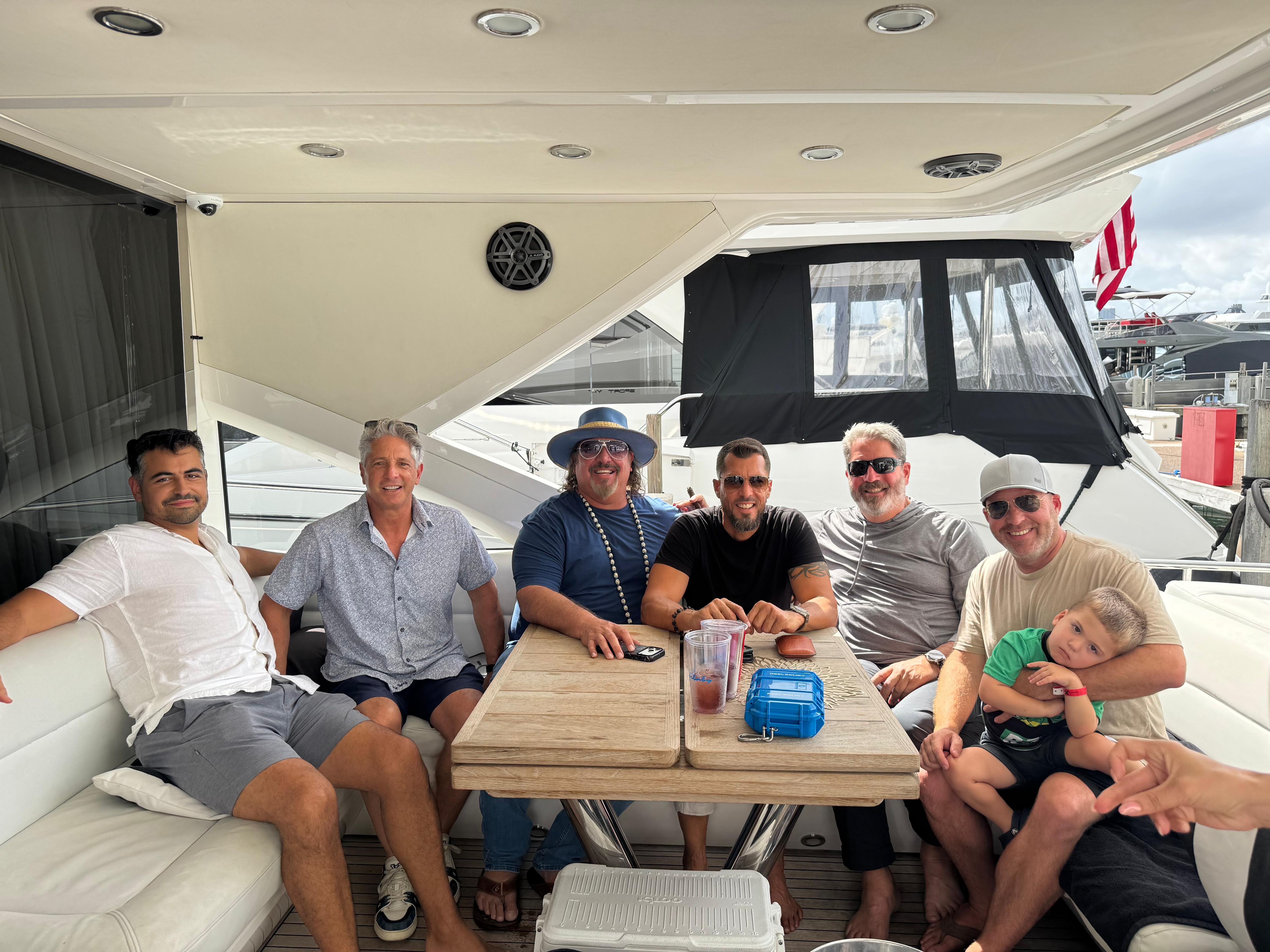 Friends relaxing inside luxury yacht cabin
